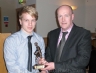 Liam Hardy presents the Christy Hardy Memorial trophy for Most Improved Footballer of the year to Peader McMullan